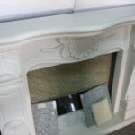 Custom Mari Buff limestone building stone fireplace surround with an ornate carved mantel and base.