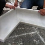 Large concave natural white marble crown molding with a smooth honed finish.