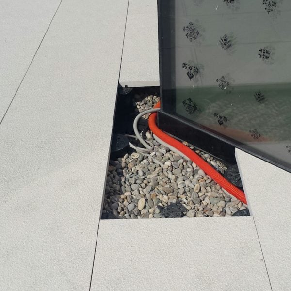 Porcelain Pavers set on Buzon Pedestals Provide Easy Access for Maintenance and Inspection of Services - HDG Building Materials