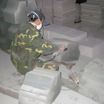 image of Skilled Craftsman Shaping and Finishing Stone by Hand Machine at HDG Building Materials Partner Factory in China