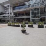 Granite-look porcelain paver by HDG in a shared vehicle and pedestrian plaza with traffic calming elements