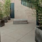 HDG tan granite-look porcelain pavers, 60x60 cm, installed in a courtyard