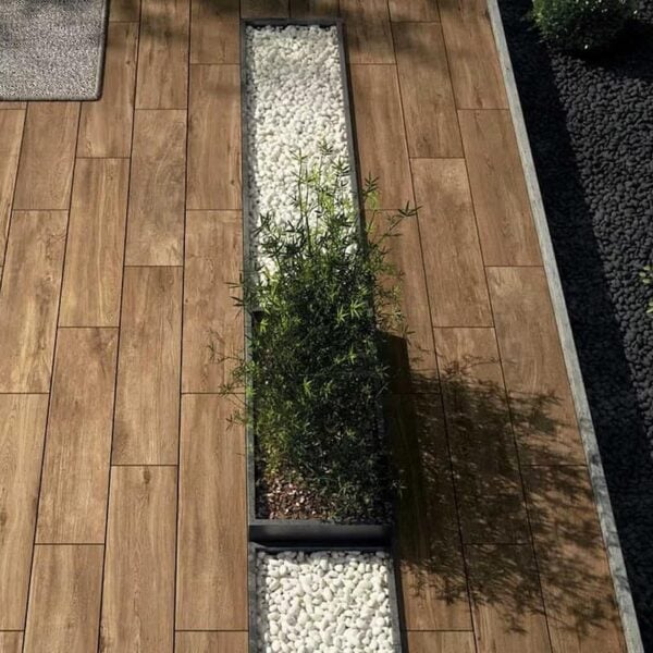 Completed outdoor terrace with 12×48-inch Espiro Indie Brown wood-look large porcelain paver planks.