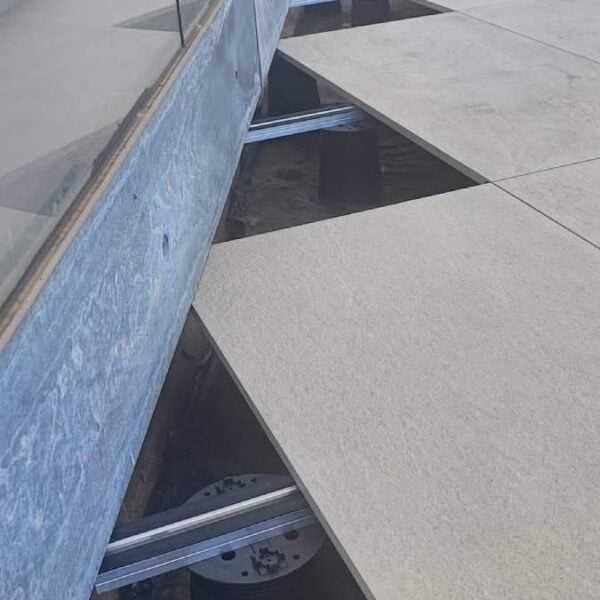 Edge Detail with Exposed Membrane, PB pedestals, E-BRS rails, and Large Format Porcelain Paver Planks.