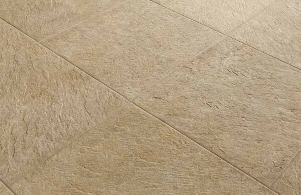 Close-up of 24x24 Rosca Gold porcelain pavers showing surface texture and installed finish.