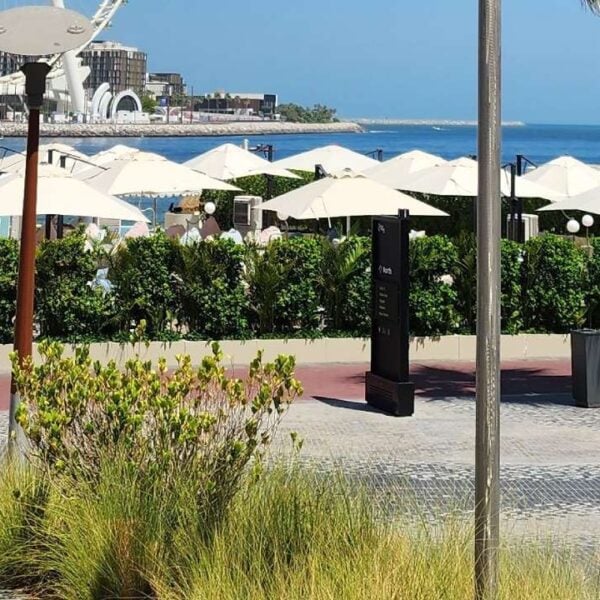 Completed granite promenade at The Beach at Jumeirah Beach Residence in Dubai featuring sweeping wave patterns, natural stone paving, and a vibrant public waterfront space.