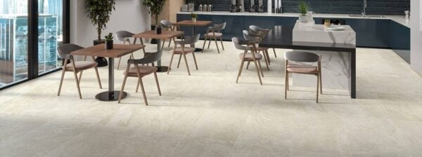 Ardesia White 24x24-inch porcelain pavers create a hospitality lounge with seating and a coffee station.