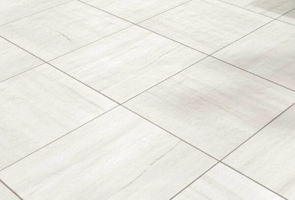 Marmo White porcelain pavers arranged in a directional cross-pattern on a pool deck, highlighting the marble-inspired grain and veining.