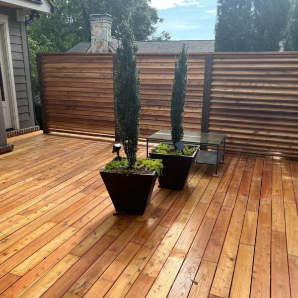 Residential deck and fence in Greenville, South Carolina, featuring Black Locust decking and siding finished with Robi Oil.