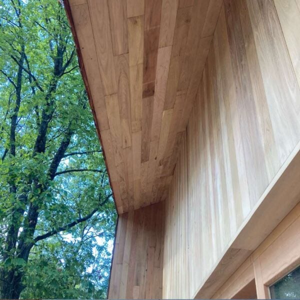 Unfinished Black Locust Nickel Gap siding and soffits showcase the natural wood grain on a home exterior.