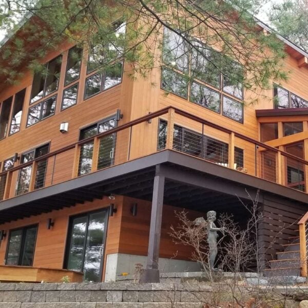 Custom lake house in Groton, Massachusetts, featuring Black Locust V-Groove siding and matching wood decking.