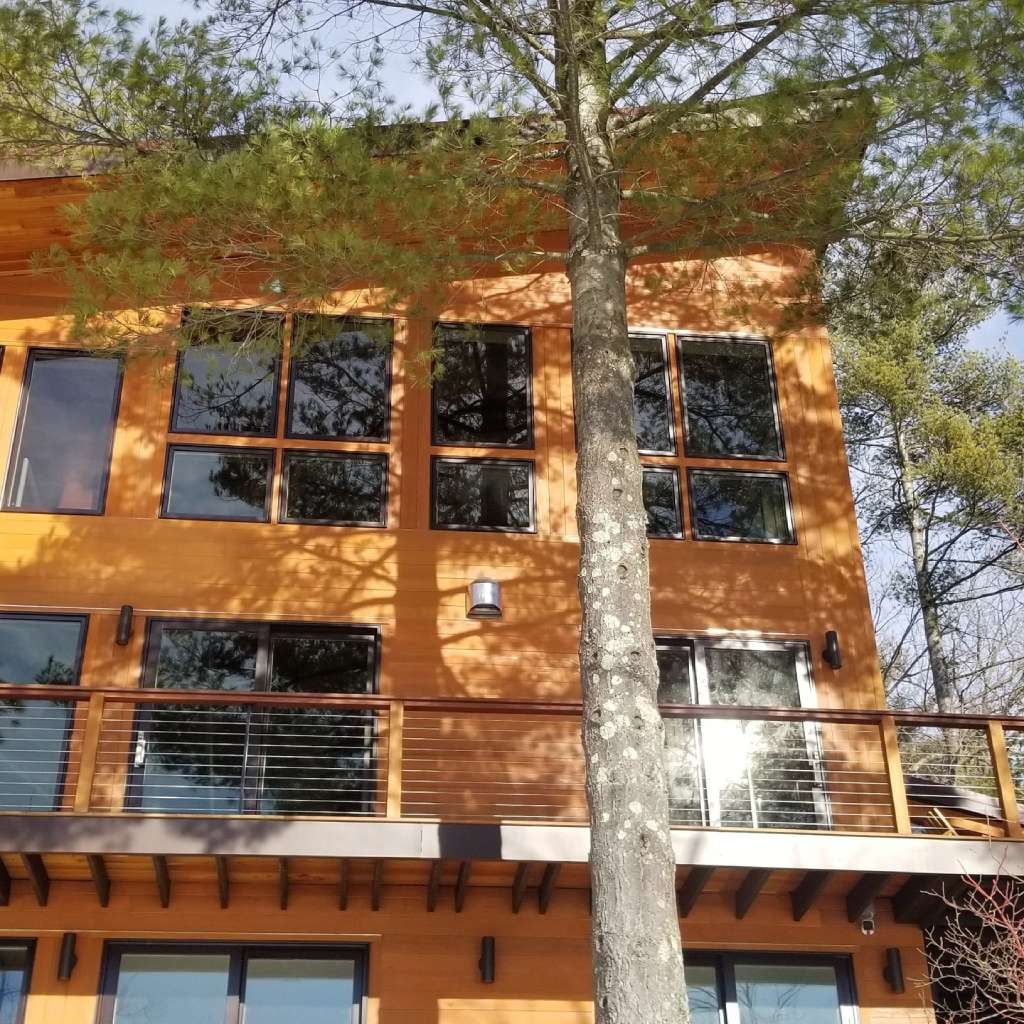 Custom lake house in Groton, Massachusetts, with Black Locust V-Groove siding and decking.